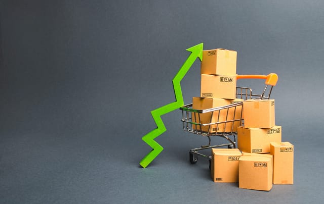 shopping-cart-with-cardboard-boxes-and-a-green-up--6XGWHXS